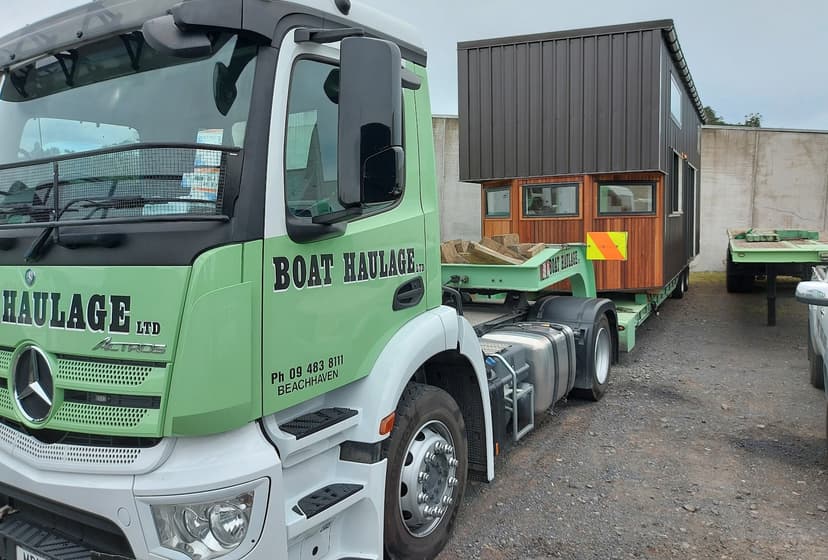 boat haulage double story tiny house in yard